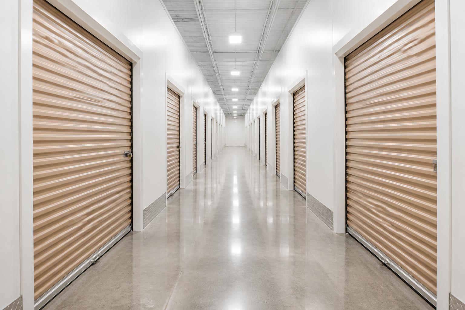 Bright indoor hallway of climate-controlled storage units